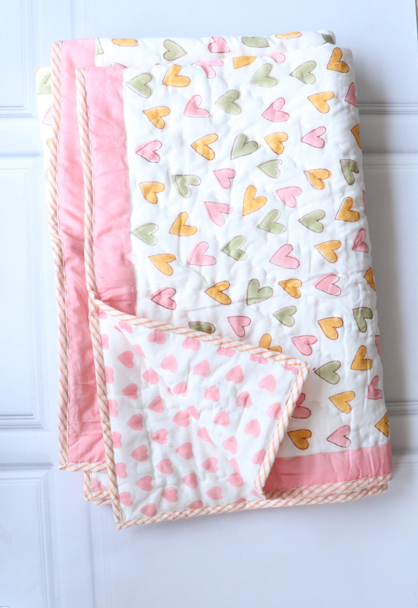 Close-up of Only Love block print design on personalized handmade baby quilt — Kari by Kriti
