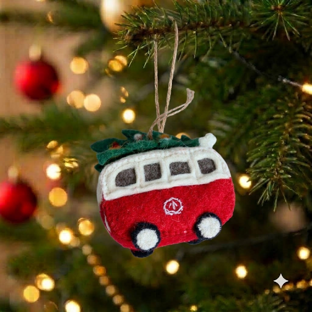 The Christmas Campervan red felt ornament with a tree on the roof, hanging on a Christmas tree