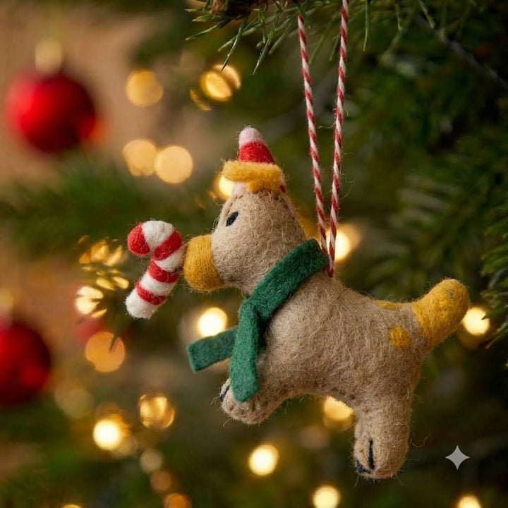 Brutus the Silliest felt puppy Christmas ornament with Santa hat and candy cane on a Christmas tree