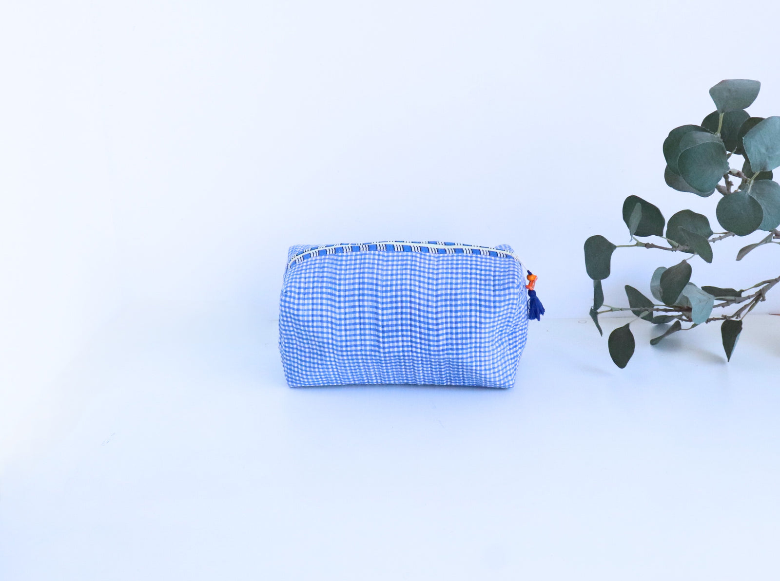 Blue checks cosmetic bag open showing block printed cotton lining