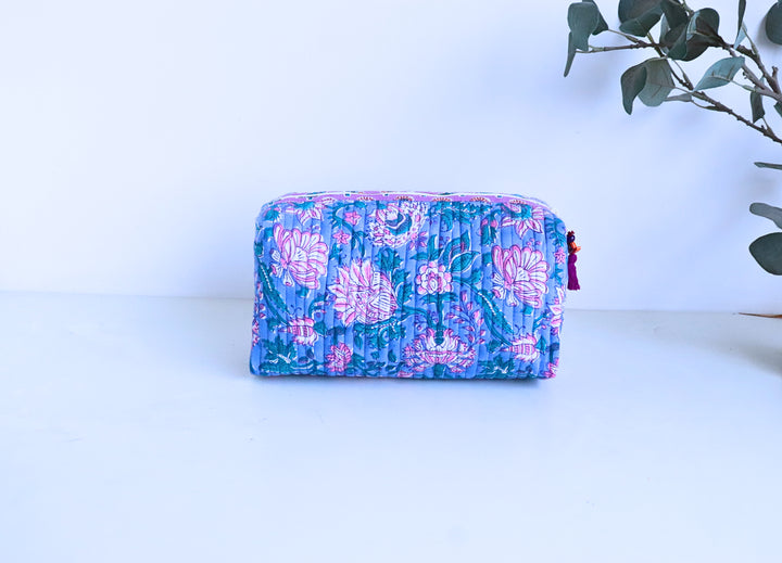 Blue and pink block print travel makeup pouch open to show block printed inner lining