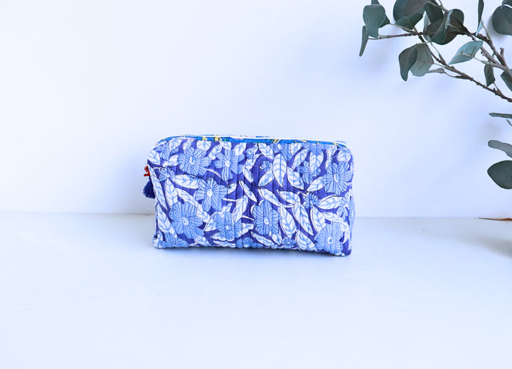 Close-up of blue hand block printed cosmetic pouch with bead tassel zip detail by Kari by Kriti
