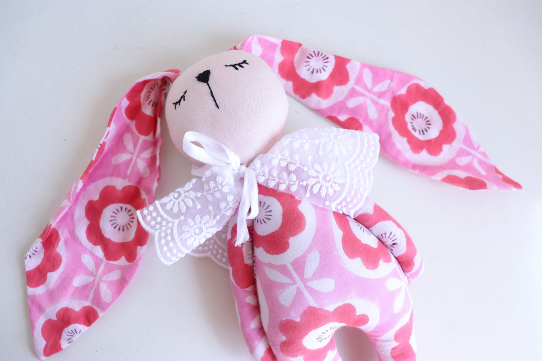 Flat lay of personalised block print bunny toys in pink and turquoise, Kari by Kriti