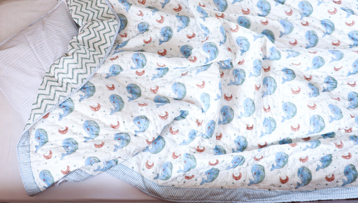 Close-up of whale print block print detailing and kantha stitching on personalized kids quilt by Kari by Kriti