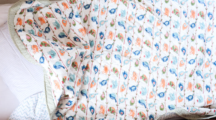 Close-up of Cheerful Birdy block print motif on personalized kids cotton quilt