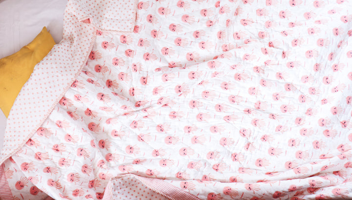 Close-up of Pink Octopus block print detail and kantha stitching on kids quilt