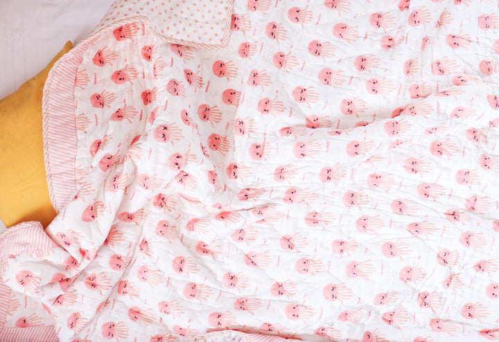 Reversible side of Pink Octopus kids quilt showing cotton fabric and personalized name detail