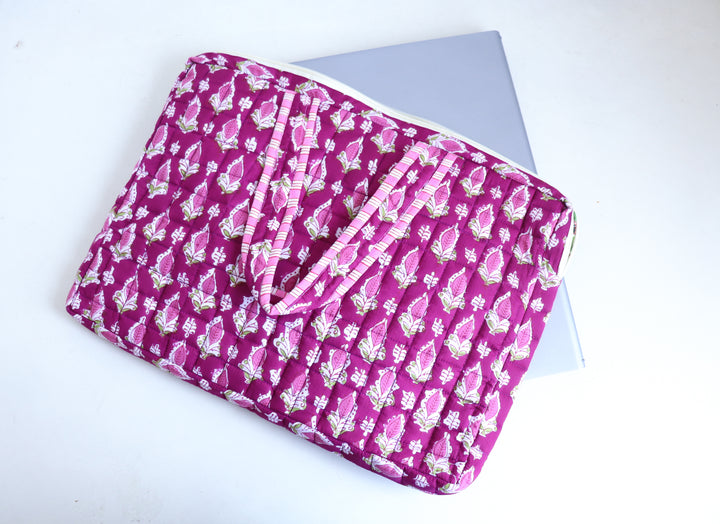 Close-up of hand block-printed magenta booti pattern on quilted cotton fabric
