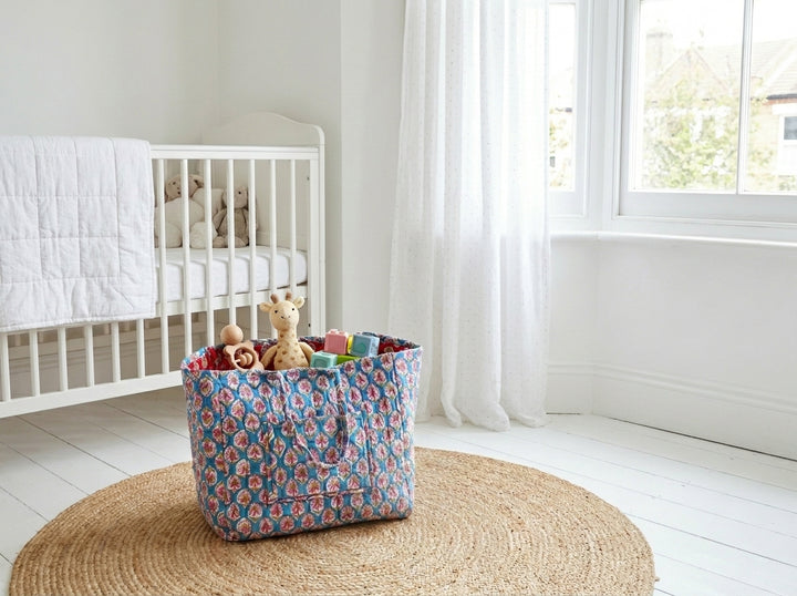 XL teal floral block print storage basket filled with blankets, ideal for nursery or living room organization