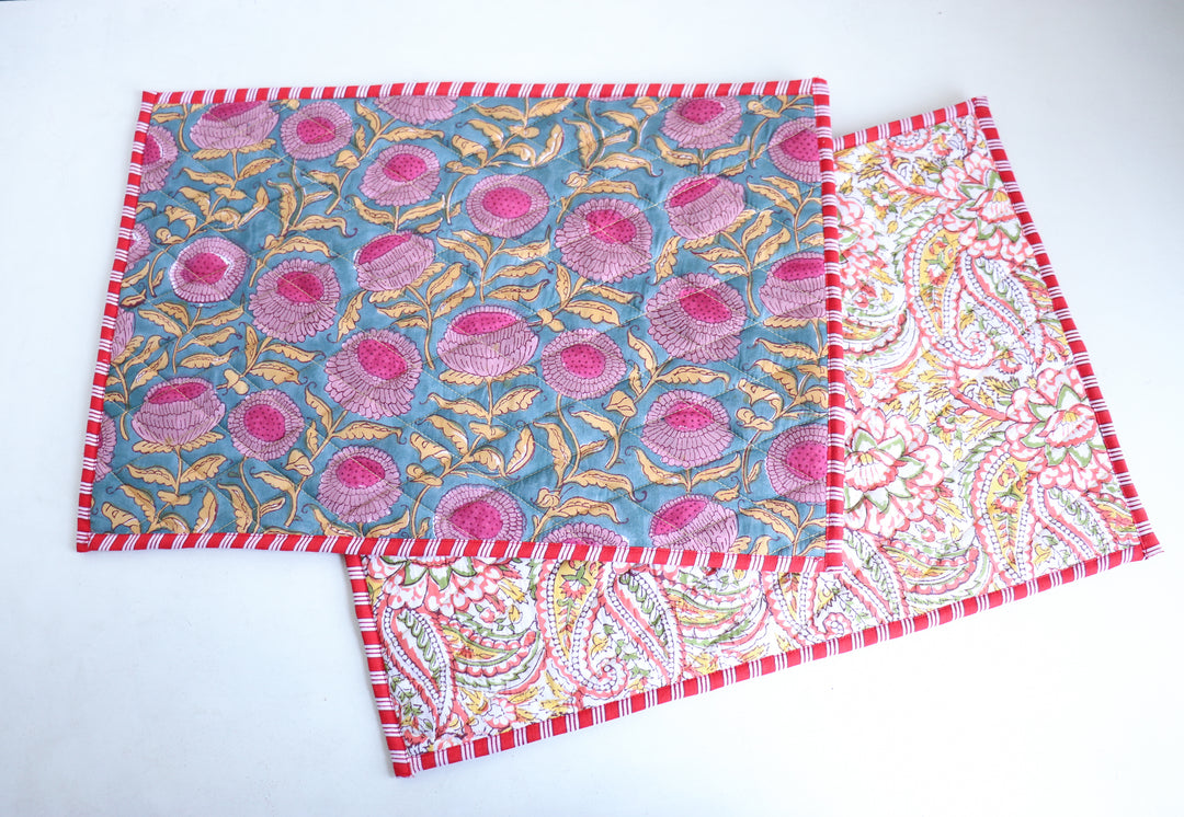Dark green block print quilted placemats set of 2, reversible design, 13x19 inches, on a dining table