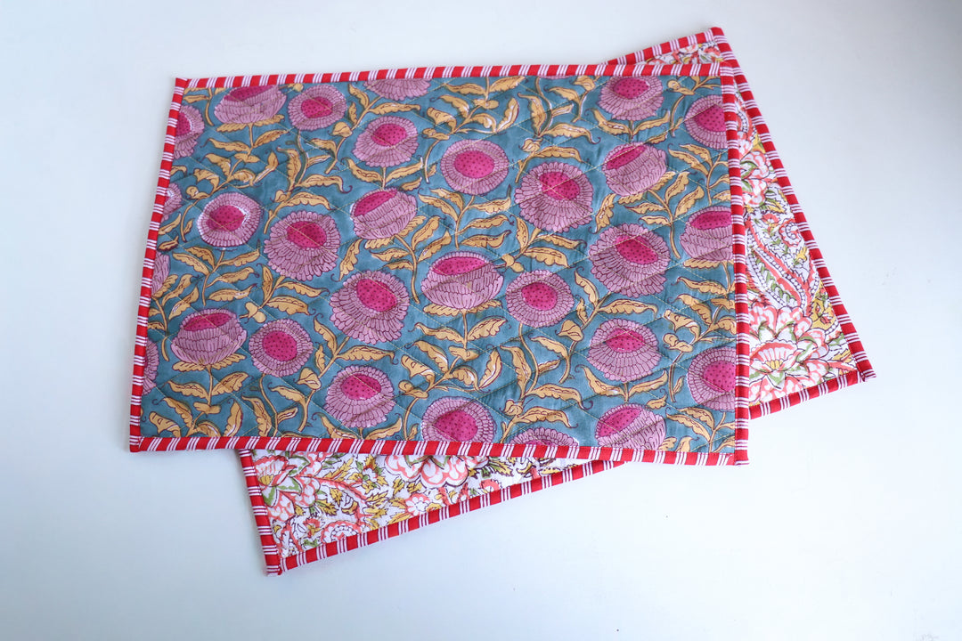 Reversible dark green block print placemat styled with dinnerware on a tablescape