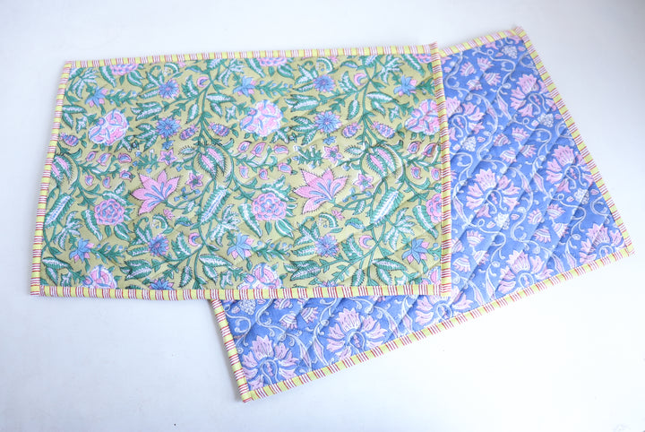 Lime green block print quilted placemats set of 2, reversible design, 13x19 inches, shown on dining table