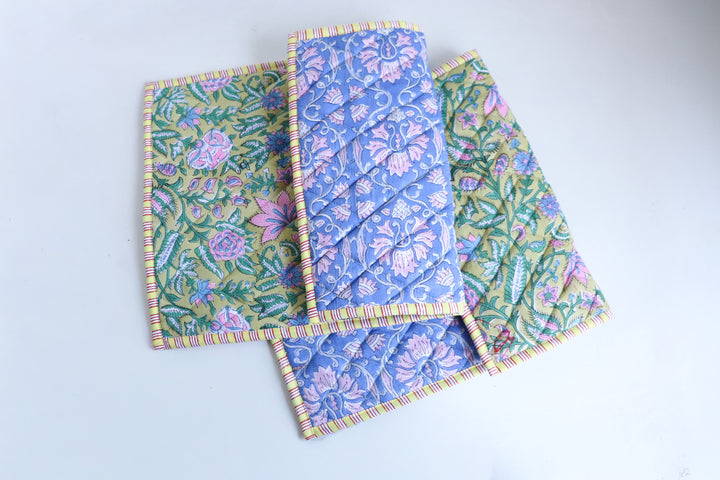 Close-up of lime green block print quilted placemat showing handmade quilted texture and foam-padded construction