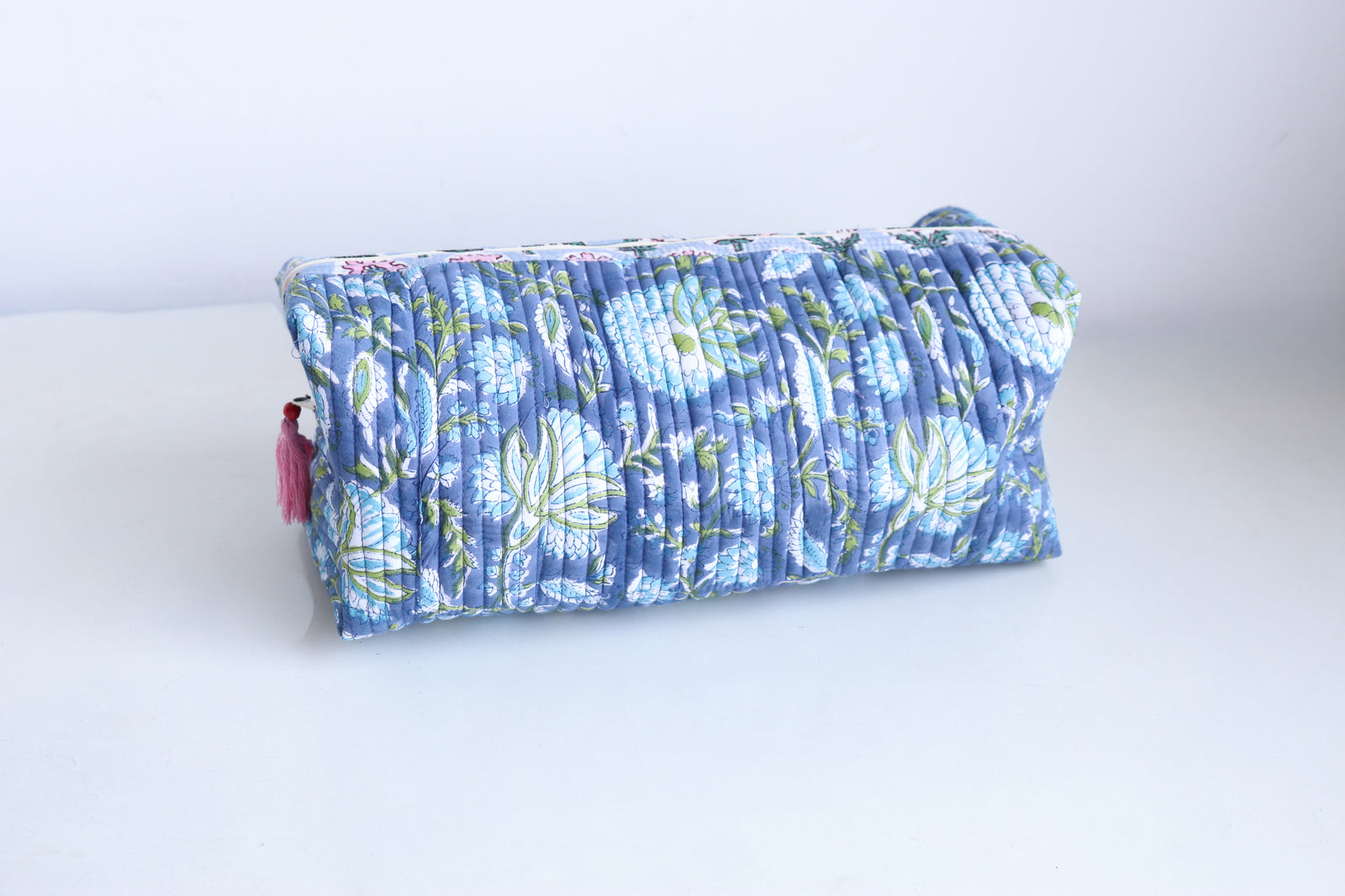 Block print Dyson Airwrap organizer bag in blue and green floral pattern, quilted cotton with tassel detail