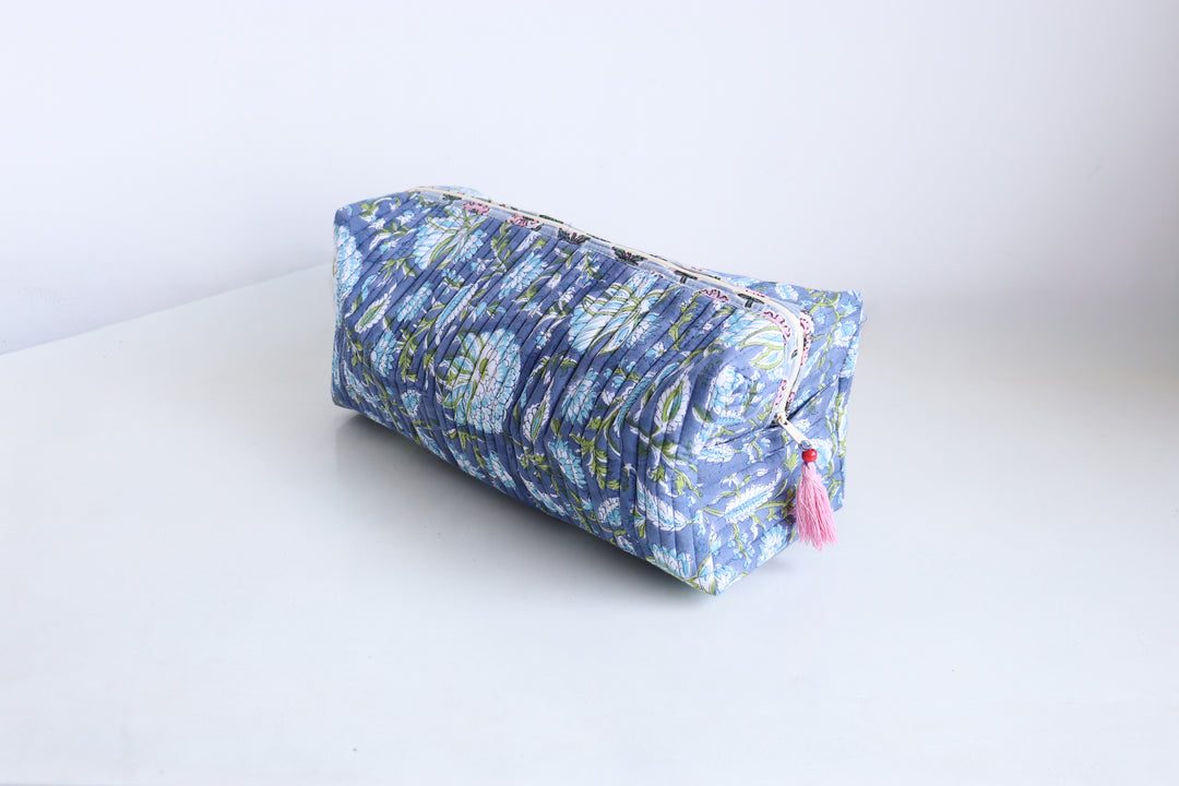 Handmade quilted Dyson Airwrap bag in blue floral block print fabric, side view showing structured shape