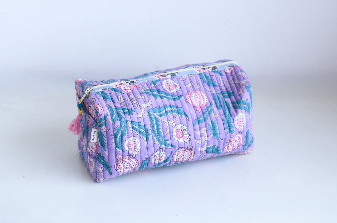 Custom name embroidery close-up on block print cosmetic pouch, handcrafted quilted toiletry bag