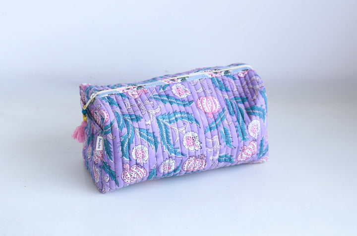 Custom name embroidery close-up on block print cosmetic pouch, handcrafted quilted toiletry bag
