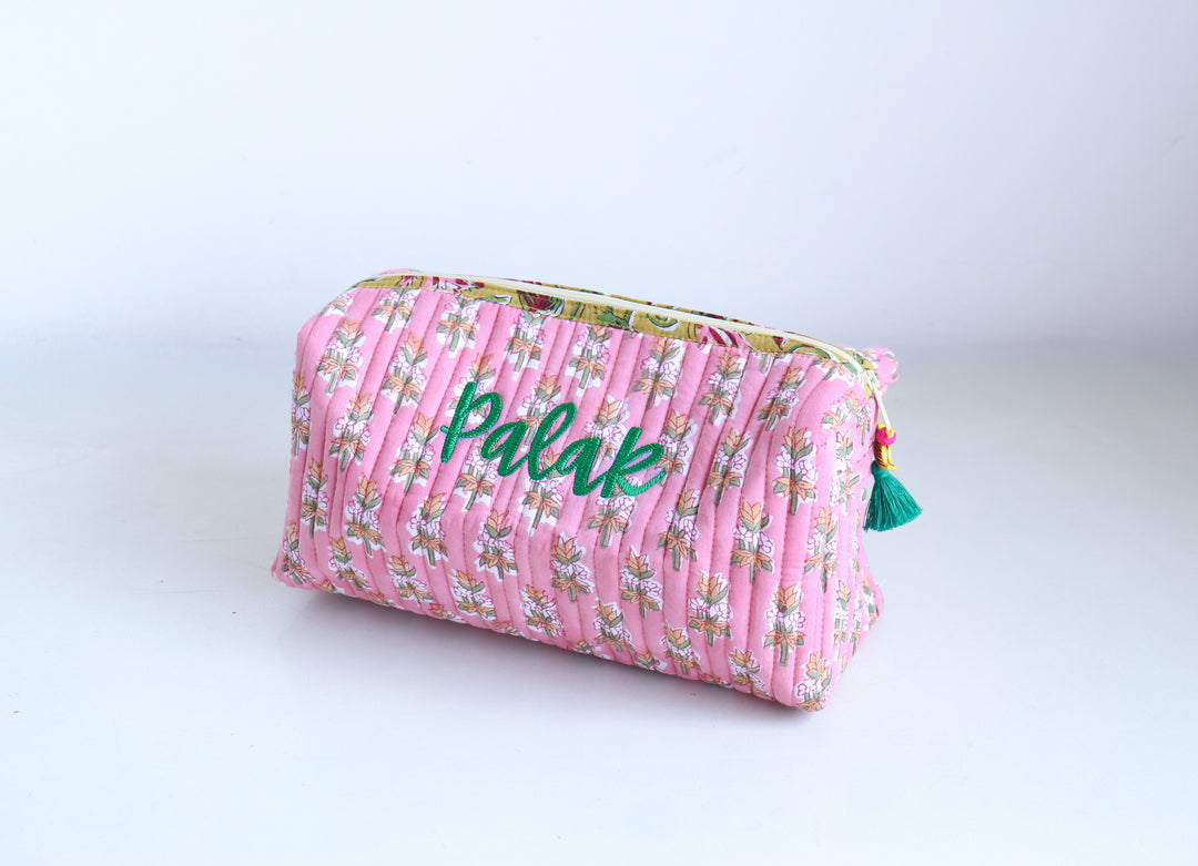 Large block print makeup bag open showing roomy interior and zip closure, personalized travel pouch