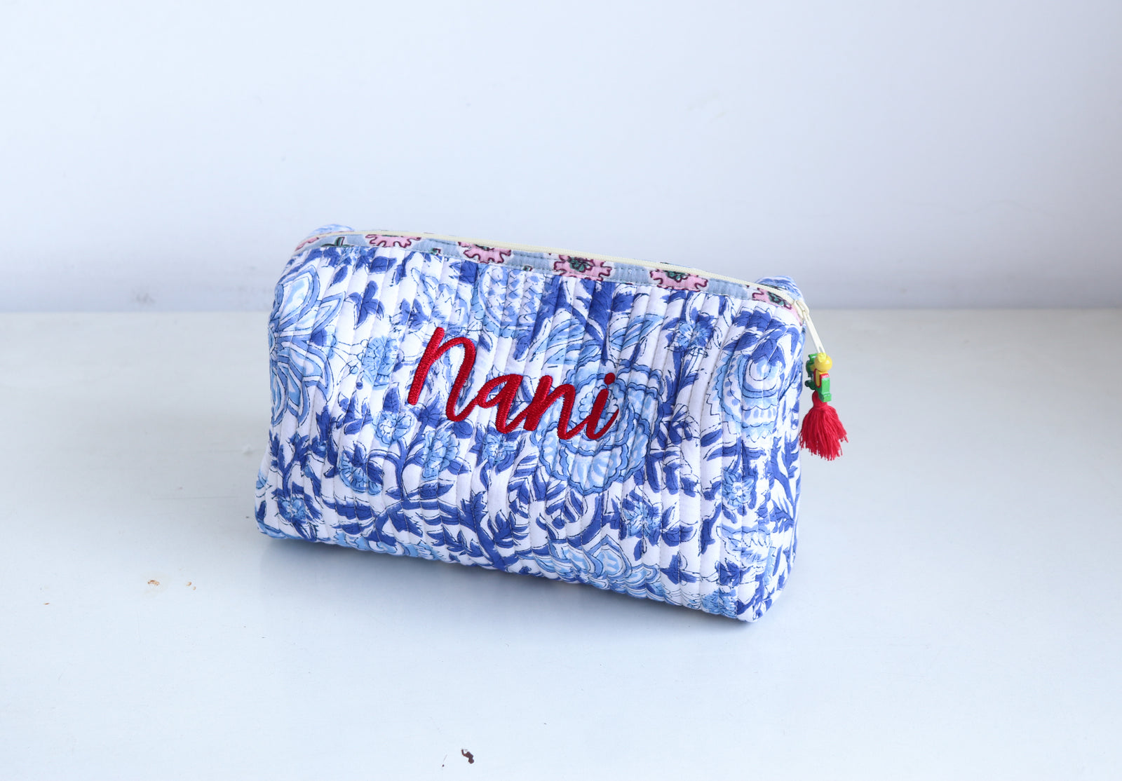 Personalized large block print makeup bag with hand-embroidered name, quilted fabric in Indian block print pattern