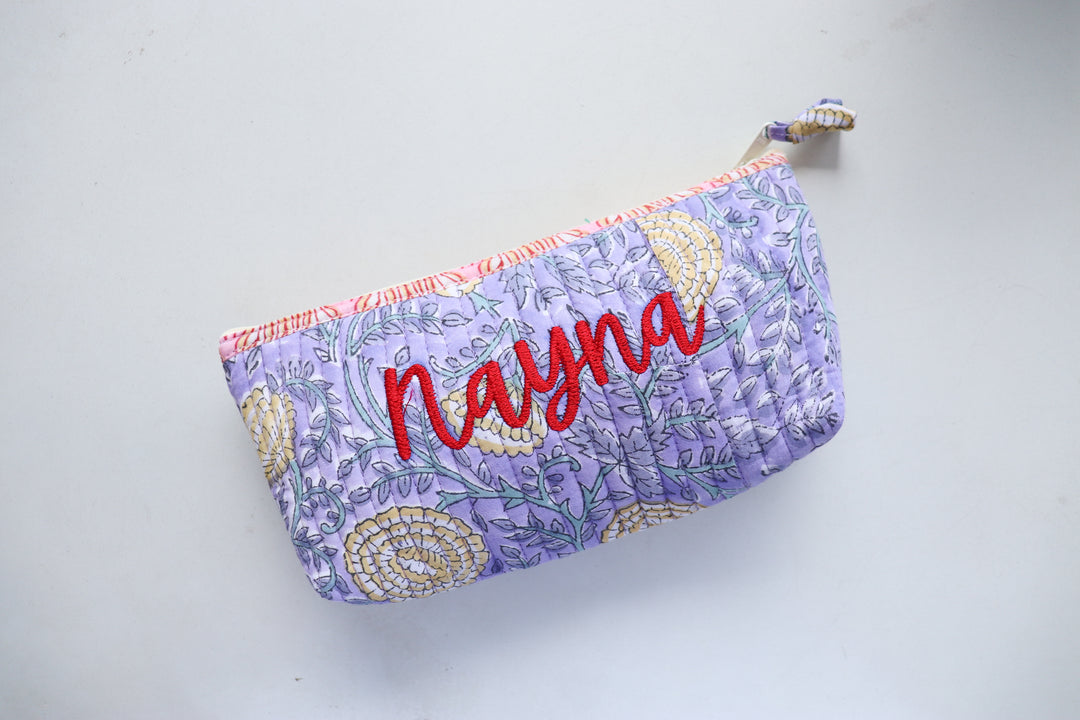 Personalized block print quilted pencil pouch with hand-embroidered name, blue floral print, zip closure