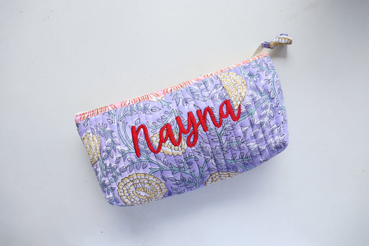 Personalized block print quilted pencil pouch with hand-embroidered name, blue floral print, zip closure