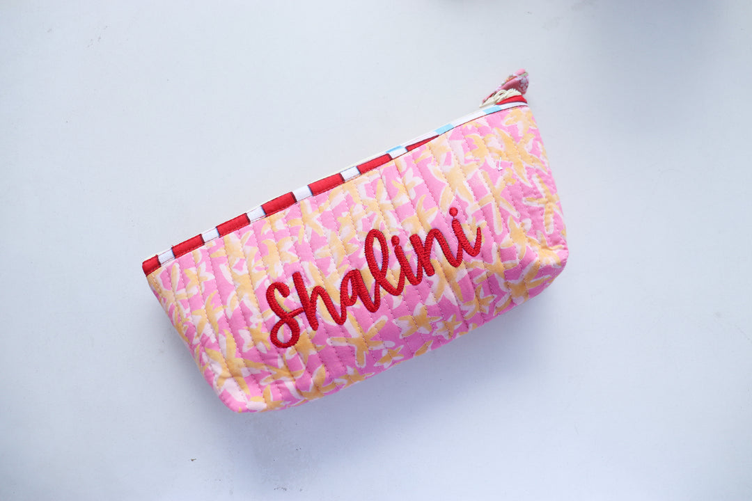 Custom name quilted pencil pouch in blue floral block print, handmade in India, shown open to display interior lining