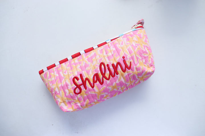 Custom name quilted pencil pouch in blue floral block print, handmade in India, shown open to display interior lining