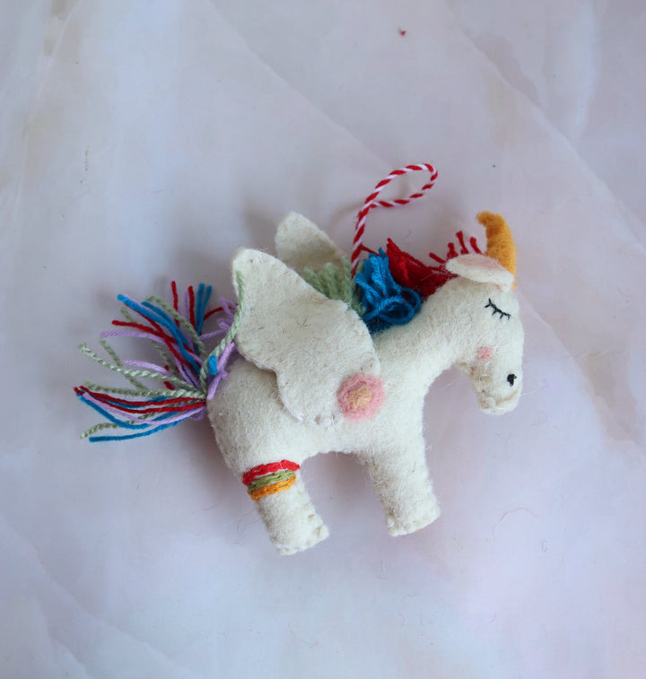 Twinkle handmade felt unicorn ornament with wings and rainbow mane, front view