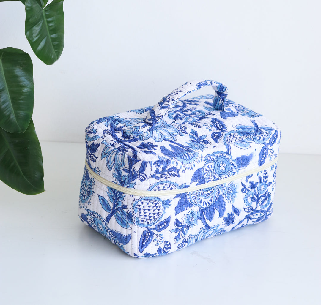 Blue and yellow hand block printed vanity bag laid flat, artisan-made toiletry case for women