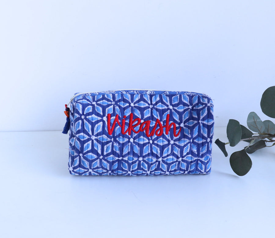 Blue geometric patterned pouch with embroidered name 