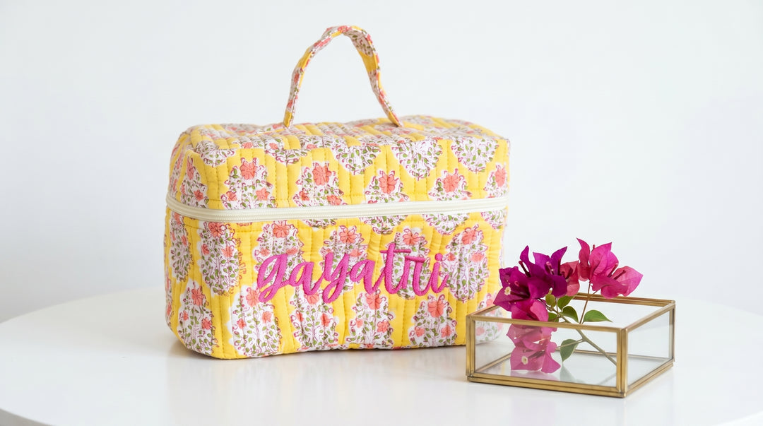 Personalized block print quilted vanity case with name, open to show structured interior and ample storage space