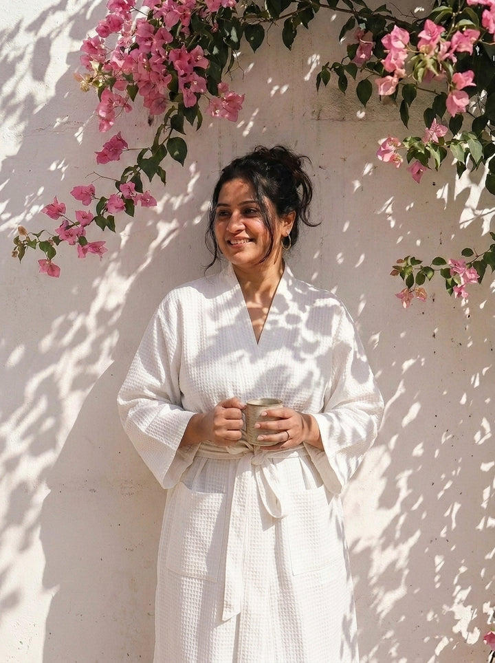 Block print cotton bath robe for women laid flat showing full length, blue and blush print with name embroidery