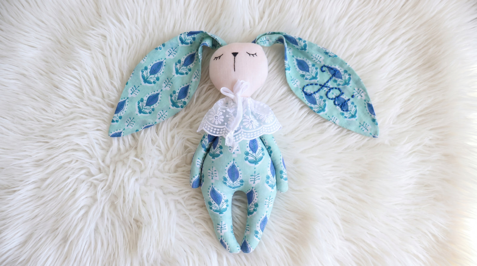 Close-up of block print pattern on pink and turquoise bunny toy, handmade in Sanganer