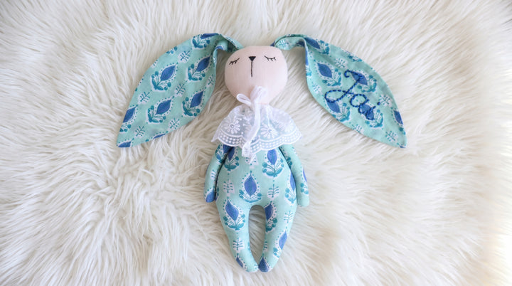 Close-up of block print pattern on pink and turquoise bunny toy, handmade in Sanganer