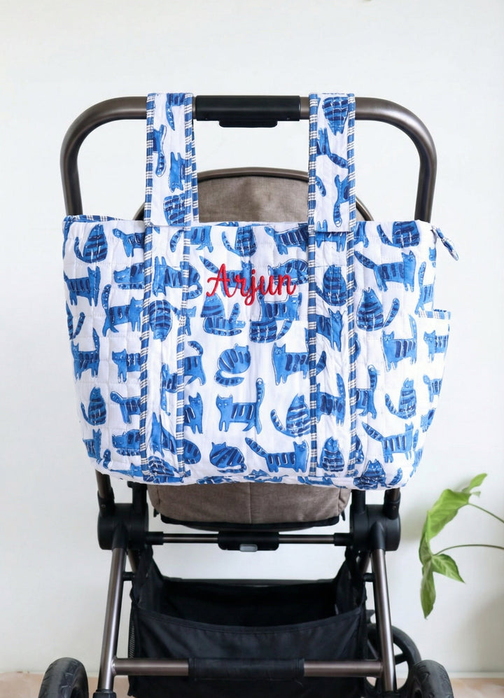 Personalized baby diaper bag in blue cat block print with custom name, stroller friendly, by Kari by Kriti
