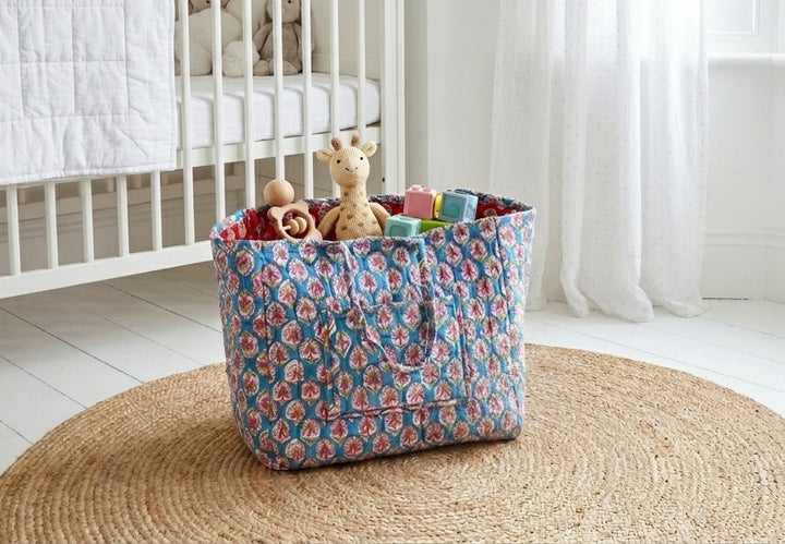 XL block print storage basket in teal booti floral pattern, hand block printed cotton, shown styled in a home setting